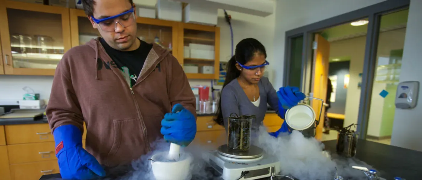 Two U N E health professions students work in a science lab